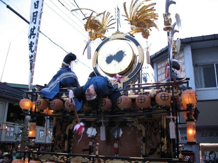 A drummer leaning backwards on top of a float.