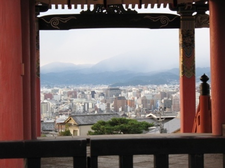 A picture taken through an arch of the Kyoto skyline