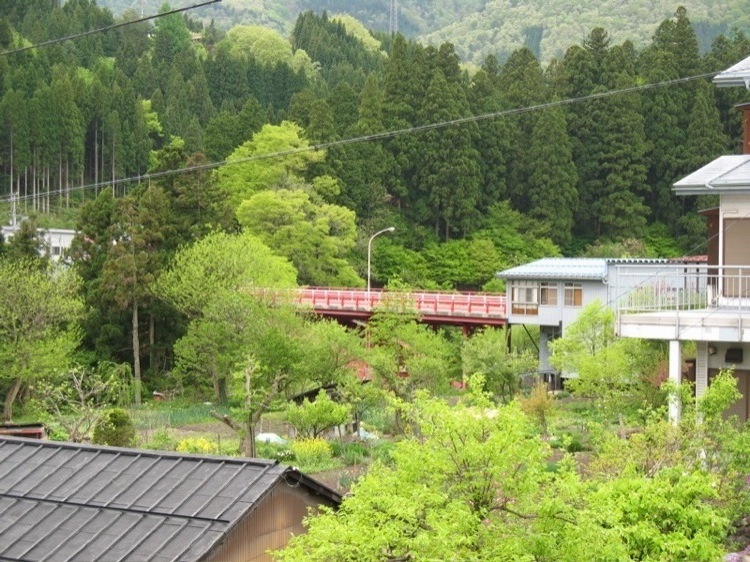 A picture of a bridge in Japan, surrounded by scenery.